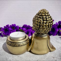 Gylden polyresin Buddha fyrfadsstage set bagfra med et enkelt fyrfadslys